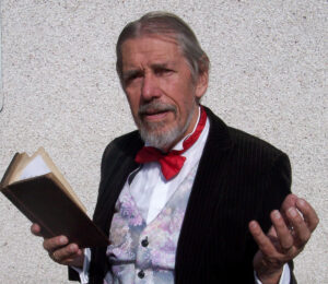 Photo of Chris Foote-Wood reading Charles Dickens